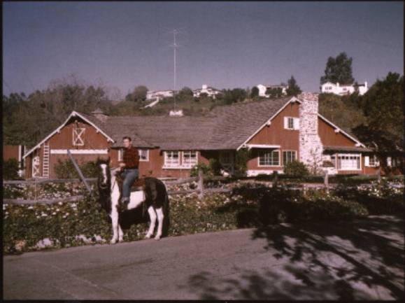 Dad on horse in front of Mandeville house-smallest